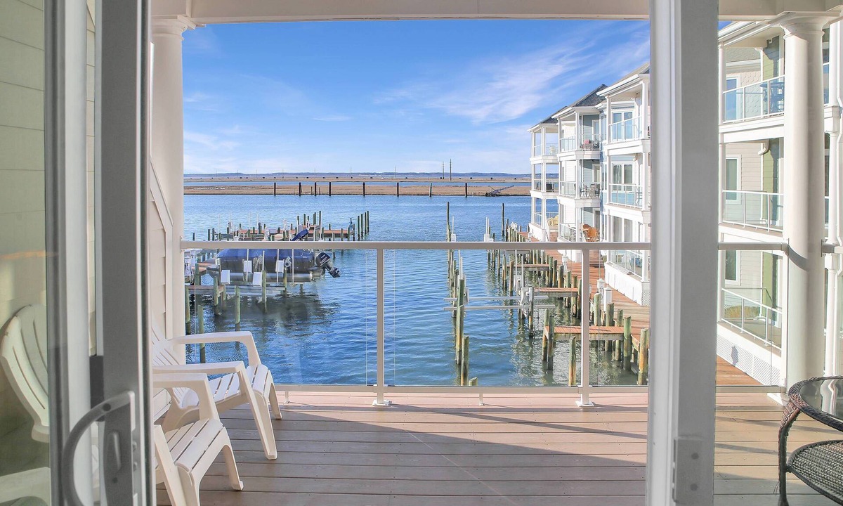 Chincoteague House | Sunset Bay Villa 212 | Waterfront Balcony + Pool + Walk to Downtown + Pet Friendly