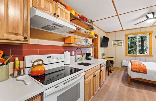 Martin City Cabin | Alpenglow blends rustic Montana character with clean, modern touches. Natural wood, warm textiles, and curated accents create a calm retreat. Unwind after a long day in the park w/100% cotton sheets, a good book, or swap stories at the fire pit.