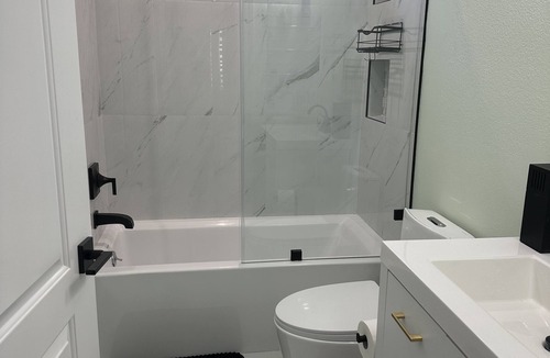 Sylmar House | Bedroom and bathroom in a quiet townhouse.