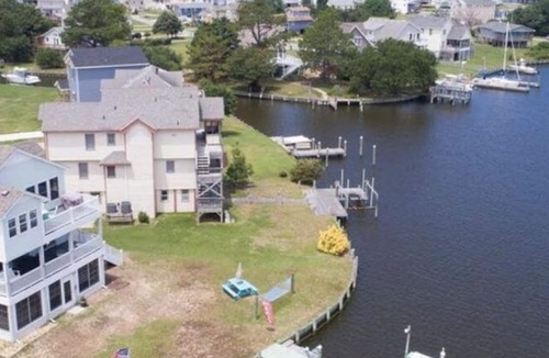 Colington Harbour House | Canal Front Home with Private Dock, Multiple Decks & Hot Tub