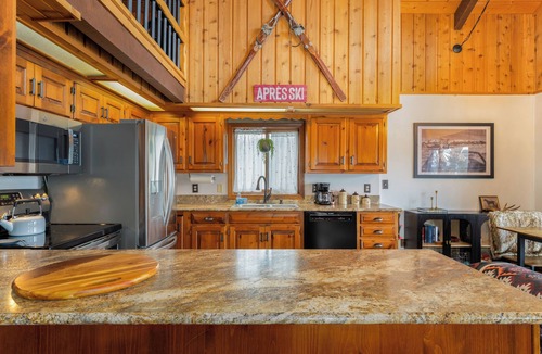 Whitefish House | Cozy Cabin w hot tub & wood-burning fireplace