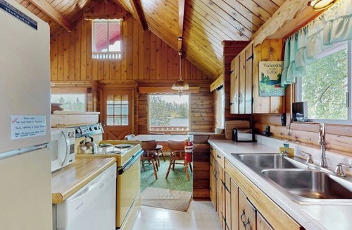 Rollins Cabin | Cozy lakefront log cabin with lake views, vintage decor, & dock