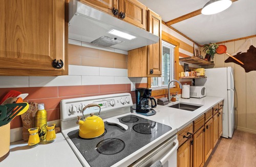 Martin City Cabin | Ditch the tent for "Retro-Chic" comfort. This spacious studio pairs high-end design with Big Sky soul—featuring a full kitchen, log-frame bed, and a modern walk-in shower. The ultimate West Glacier basecamp for your bucket-list family tour.