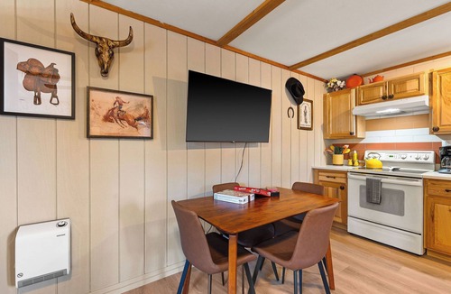 Martin City Cabin | Ditch the tent for "Retro-Chic" comfort. This spacious studio pairs high-end design with Big Sky soul—featuring a full kitchen, log-frame bed, and a modern walk-in shower. The ultimate West Glacier basecamp for your bucket-list family tour.