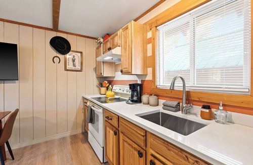 Martin City Cabin | Ditch the tent for "Retro-Chic" comfort. This spacious studio pairs high-end design with Big Sky soul—featuring a full kitchen, log-frame bed, and a modern walk-in shower. The ultimate West Glacier basecamp for your bucket-list family tour.