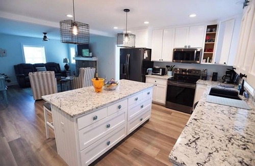 Dodds Addition House | Elegant Coastal Living: Screened-In Porch, Fire Pit, & A Short Walk to the Beach