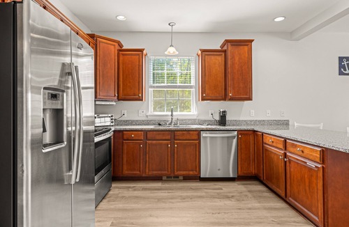 Louisa House | Lakeview escape near beach with fenced dog run, porch & dock with one boat slip