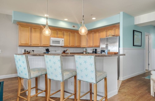 Chincoteague House | Sunset Bay Villa 206 | Luxury Condo w/Waterside Balcony, Gourmet Kitchen + Pool & Fitness