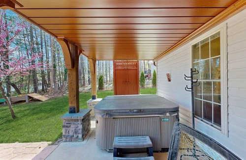 Bumpass House | Tranquil lakefront retreat with hot tub, screened porch, kayaks, and more