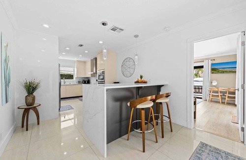 Lighthouse Point House | Waterfront~HUGE Heated Pool~Open Floor Plan~BIG Patio with Lots of Seating + Dock~Near Beaches
