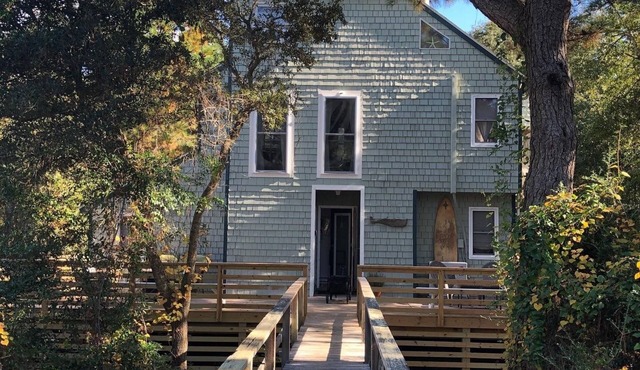 Charming, unique beach bungalow nestled in woodsy dunes. Walk to private beach.