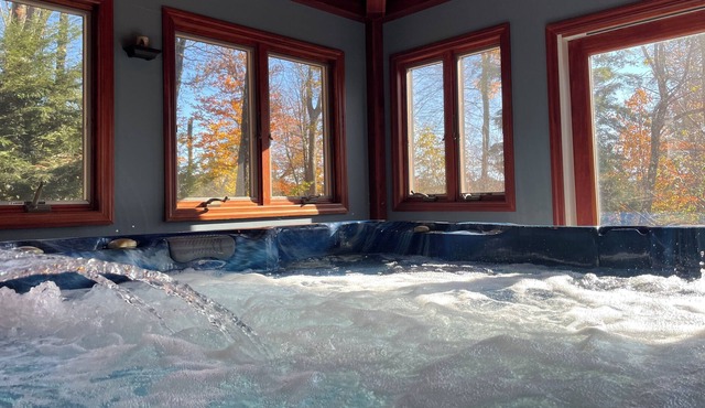 Cozy home featuring a large deck w/enclosed hot tub, game room and seasonal pool