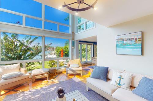 Dog-friendly riverfront home with dock, 2 balconies, waterside patio, & grill