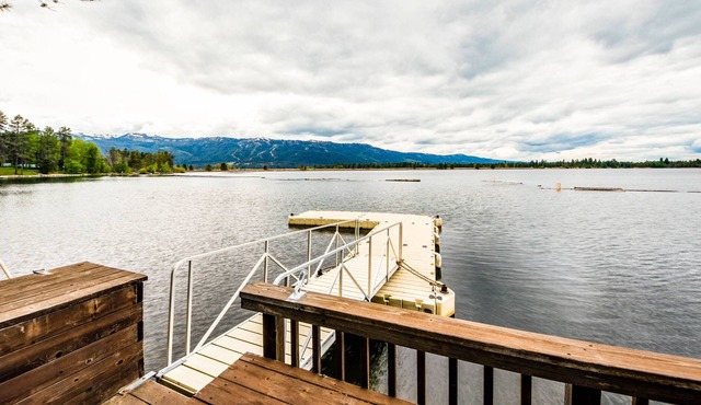 Dreamy waterfront oasis with fireplace, firepit, patio, dock, and mountain views