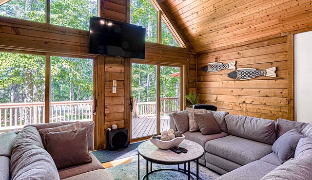 Lakefront home with boat mooring, deck, hot tub, game room & fast WiFi - dogs OK