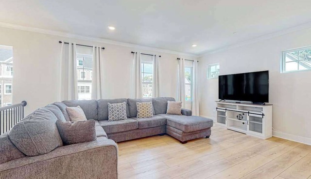 Newly built row-end townhome with water view, pool access, patio, & balcony