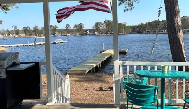 Steps from the water with a private dock, a big relaxing porch & great amenities