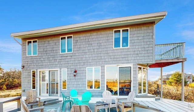 Two-story riverfront retreat with a furnished deck, views, & washer/dryer