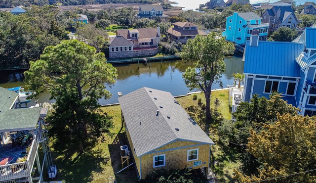 Waterfront home on a scenic canal with a dock, screened porch & fast WiFi